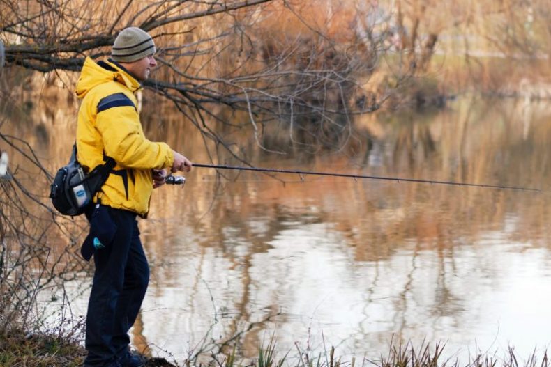 man-in-yellow-jacket-and-black-pants-standing-near-lake-3633807 man-in-yellow-jacket-and-black-pants-standing-near-lake-3633807